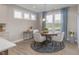 Dining room with a round wooden table, four chairs, a stylish rug, and window at 2169 Aviary Ln, Danville, IN 46122