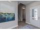 Light-filled entryway with wood-look floors, a staircase, and stylish decor at 2169 Aviary Ln, Danville, IN 46122