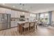 Bright kitchen featuring stainless steel appliances, center island with barstool seating, and an adjacent dining area at 2169 Aviary Ln, Danville, IN 46122