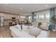 Open-concept living room features a large sofa, dining table, and kitchen island with barstool seating at 2169 Aviary Ln, Danville, IN 46122