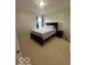 Neutral bedroom showcasing bed with a padded headboard, side table, and neutral carpet at 2231 Abbey St, Brownsburg, IN 46112