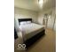 Bright bedroom with a bed, white bedding, a light fixture, and neutral carpet at 2231 Abbey St, Brownsburg, IN 46112
