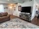 Comfortable living room featuring a plush sofa, area rug, and mounted television at 2231 Abbey St, Brownsburg, IN 46112