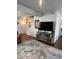 Cozy living room featuring comfortable seating, area rug, television, and staircase at 2231 Abbey St, Brownsburg, IN 46112
