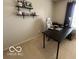 Corner view of a home office setup with a black desk, white chair, and floating wall shelves at 2231 Abbey St, Brownsburg, IN 46112