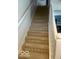 Carpeted staircase with white railings, providing safe and stylish access to upper levels at 2231 Abbey St, Brownsburg, IN 46112