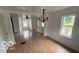 Dining room featuring hardwood floors and views of the front yard at 252 Ringwood Way, Anderson, IN 46013