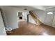 Living room featuring a stone fireplace, with wood-look laminate flooring throughout at 252 Ringwood Way, Anderson, IN 46013