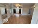 Spacious living room with wood-look laminate flooring, featuring modern lighting fixtures at 252 Ringwood Way, Anderson, IN 46013