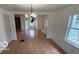 Living room featuring wood-look laminate flooring, with a decorative chandelier at 252 Ringwood Way, Anderson, IN 46013