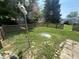 Spacious backyard featuring a birdhouse pole, mature trees, and a small section of fence at 2937 S Allen Dr, New Palestine, IN 46163