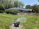 Scenic backyard with lush green grass, a wooden fence, and a fire pit for outdoor enjoyment at 2937 S Allen Dr, New Palestine, IN 46163