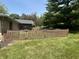 Backyard with green grass, a wooden fence, and plenty of shade from mature trees at 2937 S Allen Dr, New Palestine, IN 46163