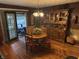 Cozy dining room showcases hardwood floors, vintage hutch, and sliding glass doors at 2937 S Allen Dr, New Palestine, IN 46163