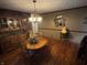 Cozy dining room features hardwood floors and vintage hutch with a chandelier overhead at 2937 S Allen Dr, New Palestine, IN 46163