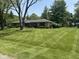 Charming ranch-style home with a well-manicured lawn and mature trees in a quiet, residential neighborhood at 2937 S Allen Dr, New Palestine, IN 46163