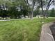 Large front yard with lush green lawn, mature trees, and a sidewalk leading to a traditional home in a quiet neighborhood at 2937 S Allen Dr, New Palestine, IN 46163