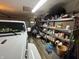 Spacious garage featuring lots of storage space, shelving and parking for vehicles at 2937 S Allen Dr, New Palestine, IN 46163