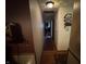 Narrow hallway featuring hardwood floors, decorative elements, and neutral wall colors at 2937 S Allen Dr, New Palestine, IN 46163