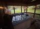 Relaxing hot tub inside a screened porch with ambient lighting, offering a private outdoor spa experience at 2937 S Allen Dr, New Palestine, IN 46163