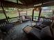 Inviting screened porch with cozy seating, string lights, and a peaceful backyard view at 2937 S Allen Dr, New Palestine, IN 46163