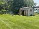 View of a shed featuring green grass, an open door and fire pit nearby at 2937 S Allen Dr, New Palestine, IN 46163