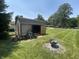 View of a shed with its doors open and a fire pit on green grass at 2937 S Allen Dr, New Palestine, IN 46163
