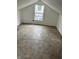 Bright attic space with a window and paneled flooring, offering storage and potential living space at 3201 W 22Nd St, Indianapolis, IN 46222