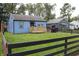 Charming blue home with new porch and black picket fence, offers a blend of comfort and style at 3201 W 22Nd St, Indianapolis, IN 46222