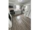 Modern kitchen with stainless steel appliances, gray cabinets, and wood floors, perfect for cooking enthusiasts at 3201 W 22Nd St, Indianapolis, IN 46222