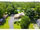 Beautiful aerial view of a home with a long driveway, solar panels, lush trees and a large pond at 3265 Tulip Dr, Indianapolis, IN 46227