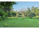 Beautifully landscaped backyard featuring a manicured lawn, mature trees, and wildlife offering a peaceful retreat at 3265 Tulip Dr, Indianapolis, IN 46227