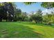 Expansive backyard with lush green grass and mature trees that offer a picturesque and serene outdoor living space at 3265 Tulip Dr, Indianapolis, IN 46227