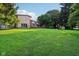 Expansive backyard with lush lawn and mature trees providing privacy at 3265 Tulip Dr, Indianapolis, IN 46227