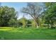 Lush backyard with a pond and mature trees adding privacy at 3265 Tulip Dr, Indianapolis, IN 46227