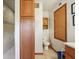 Bathroom featuring a tiled shower, toilet, and wooden storage cabinets at 3265 Tulip Dr, Indianapolis, IN 46227