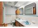 Retro bathroom with a double sink vanity and blue fixtures and tile at 3265 Tulip Dr, Indianapolis, IN 46227