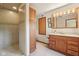 Well-lit bathroom featuring a tiled shower and a wooden vanity with ample storage at 3265 Tulip Dr, Indianapolis, IN 46227