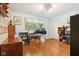 Bedroom with hardwood floors, light blue walls, and a large window at 3265 Tulip Dr, Indianapolis, IN 46227