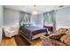 Bedroom featuring a cozy armchair, a bed with a blue comforter, and a bright window at 3265 Tulip Dr, Indianapolis, IN 46227