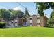 Charming brick home boasts a well-manicured lawn and mature trees at 3265 Tulip Dr, Indianapolis, IN 46227