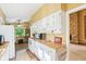 Bright kitchen with wood countertops and white cabinets with an adjoining eat-in area at 3265 Tulip Dr, Indianapolis, IN 46227