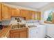 Convenient laundry area with ample cabinet space and sink near the window at 3265 Tulip Dr, Indianapolis, IN 46227