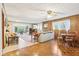 Inviting living room features a brick fireplace, wood paneling, and access to outdoor space at 3265 Tulip Dr, Indianapolis, IN 46227