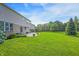 Large backyard featuring a patio and spacious lawn, ideal for recreation and relaxation at 3345 Kilkenny Cir, Carmel, IN 46032