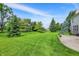 Spacious green backyard featuring beautiful landscape and a well-manicured lawn at 3345 Kilkenny Cir, Carmel, IN 46032