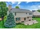 View of the property's rear, revealing a patio area and tidy landscaping, enhanced by a verdant tree at 3345 Kilkenny Cir, Carmel, IN 46032