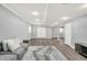 Basement with wood floor, neutral gray walls, sliding door, and gray couch at 3345 Kilkenny Cir, Carmel, IN 46032