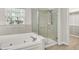 Bathroom with soaking tub, glass-enclosed shower and view to walk-in closet at 3345 Kilkenny Cir, Carmel, IN 46032