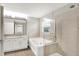 Bathroom featuring double sink vanity, soaking tub with tile surround and glass-enclosed shower at 3345 Kilkenny Cir, Carmel, IN 46032